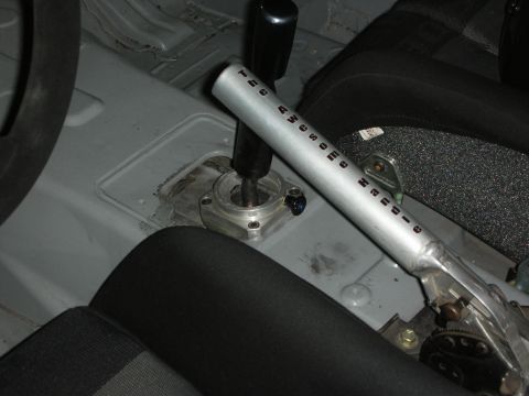 1998 Ford Crown Victoria - Close-up of a car's interior, focusing on the handbrake and gear shifter, with a racing seat visible.
