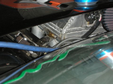 1998 Ford Crown Victoria - Close-up view of a modified engine bay, showing custom welding on the radiator support and a blue hose.