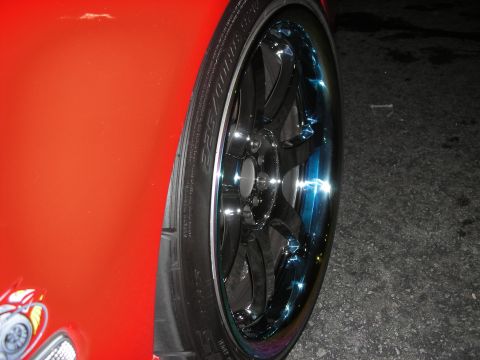 1998 Ford Crown Victoria - Custom chrome wheel and tire detail on a red vehicle.