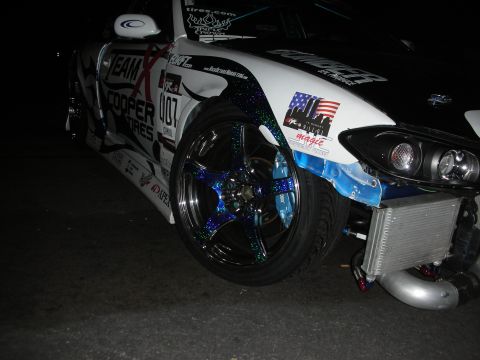 1998 Ford Crown Victoria - Customized drift car with unique wheel and body graphics, front view shows aftermarket parts.