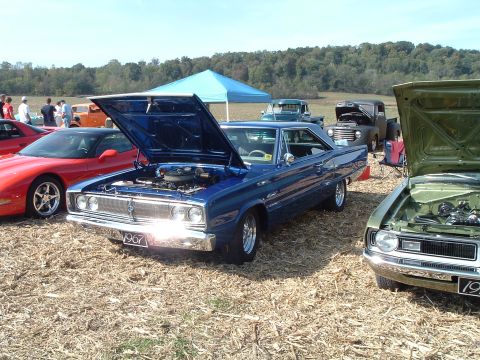 2001 Ford Taurus - A blue 1967 Dodge Coronet is displayed with its hood open at an outdoor car show.