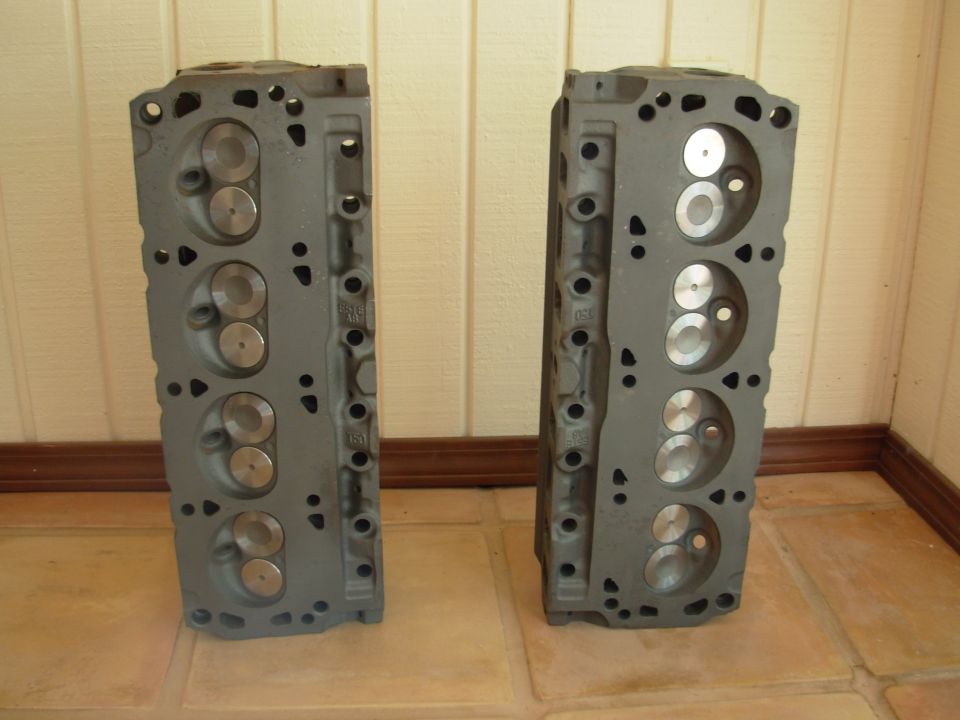 Two gray engine cylinder heads side-by-side