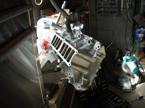 1994 Ford Bronco - Engine intake manifold being worked on in a garage setting.