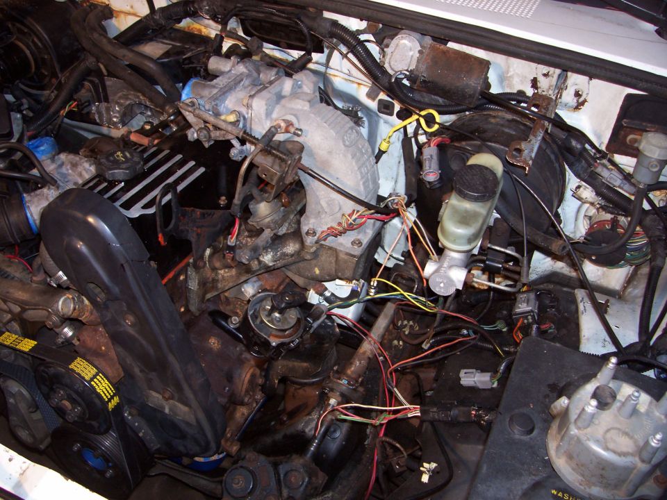 Engine bay with visible belts and wiring