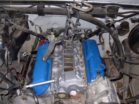 1994 Ford Bronco - The engine bay is shown with the intake manifold removed, exposing the fuel rails and valve covers.
