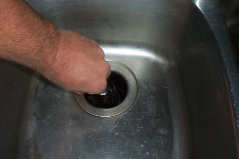 1994 Ford F-150 - A hand is shown reaching into a sink drain, with the Supermotors.net logo visible in the lower right corner.