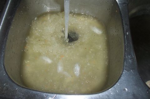 1994 Ford F-150 - Water running into a sink filled with murky liquid and debris.