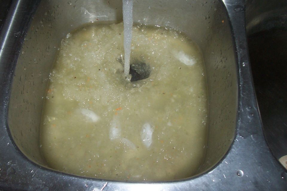 Sink with running water and debris