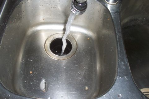 1994 Ford F-150 - Water flows into a double-basin stainless steel kitchen sink.