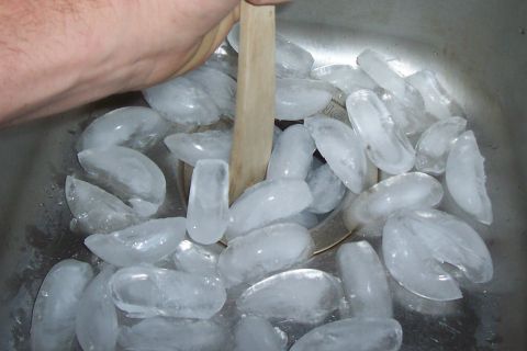 1994 Ford F-150 - A hand stirs ice cubes in a sink, with a Supermotors.net logo visible.