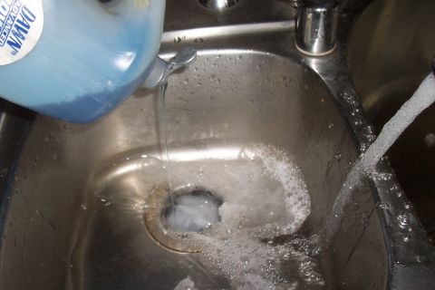 1994 Ford F-150 - Water and soap fill a sink, with a faucet running in the background.