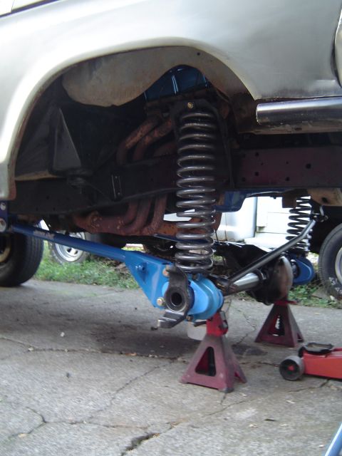 1978 Ford Bronco - Front suspension components of a 1978 Ford Bronco, a lifted chassis supported by jack stands.