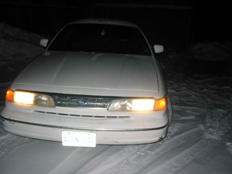 1996 Ford Crown Victoria - Front view of a 1995 Ford Crown Victoria parked in the snow at night.