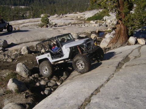 1986 Ford Bronco - An off-road vehicle navigates a challenging rocky incline, its capabilities.