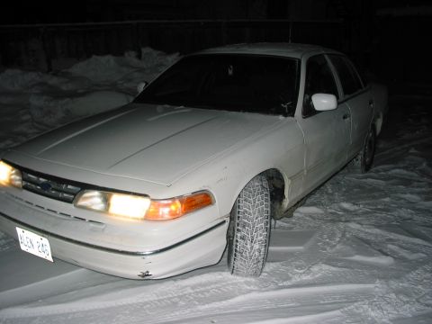 1996 Ford Crown Victoria - A 1996 Ford Crown Victoria is seen from the front 3/4 angle, parked in a snowy environment.
