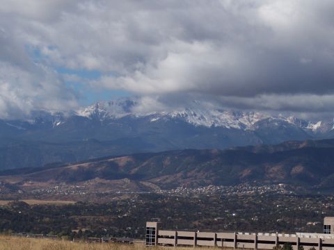 1972 Ford Ranchero - A wide view shows snow on mountain peaks above a town, with a cloudy sky.