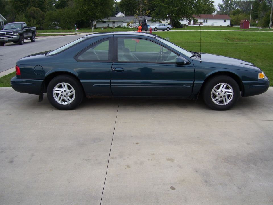 Side view of a 1997 Ford Thunderbird coupe in dark green