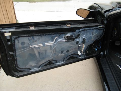 2002 Pontiac Trans Am - The interior door panel has been removed, exposing the internal components and wiring harness.