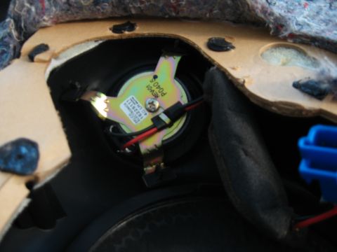 2002 Pontiac Trans Am - Close-up of a car door speaker, showing its mounting bracket and wiring.