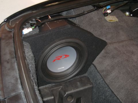 2002 Pontiac Trans Am - Aftermarket subwoofer installed in the trunk of a car.