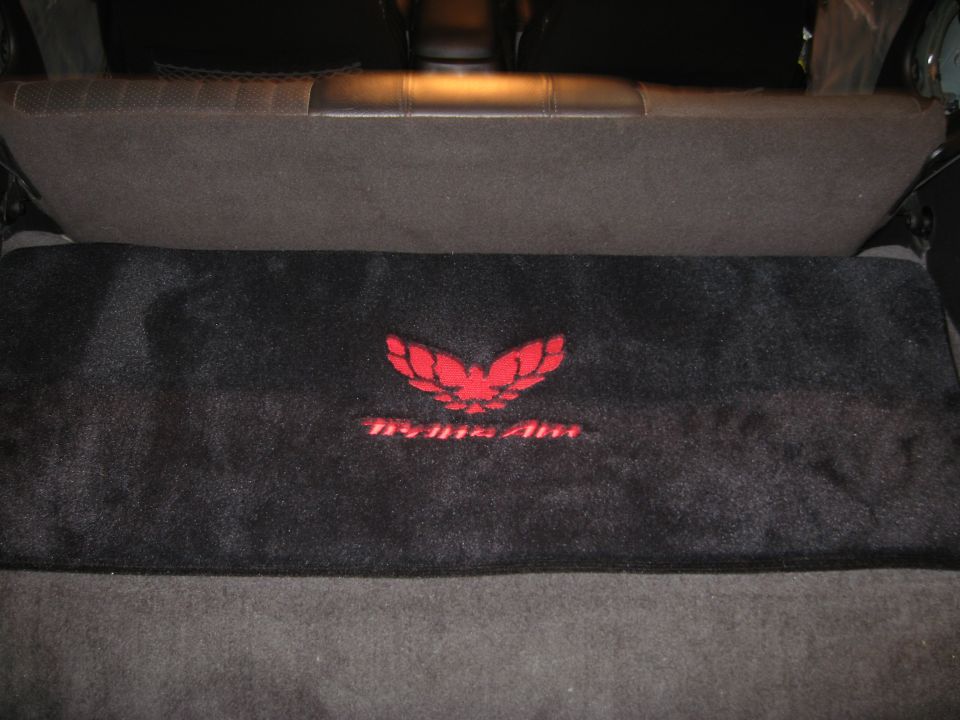 Black floor mat with red Trans Am bird logo and text