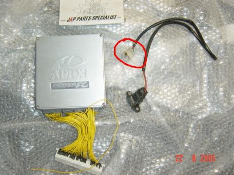 1991 Mazda RX-7 - An APEXi Power FC engine control unit and associated wiring are laid out on a bubble-wrapped surface.