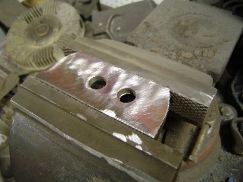 1978 Ford Bronco - A metal bracket is secured in a vise, ready for work, with shop tools visible.