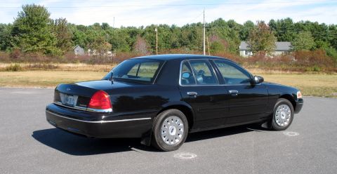 1998 Ford Crown Victoria - This 1998 Ford Crown Victoria is captured from a rear three-quarter perspective, highlighting its classic sedan profile.