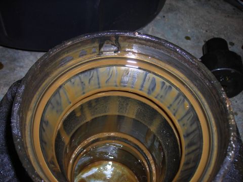 1995 Ford F-250 - The interior of a differential housing shows signs of wear and rust, indicating a need for service.