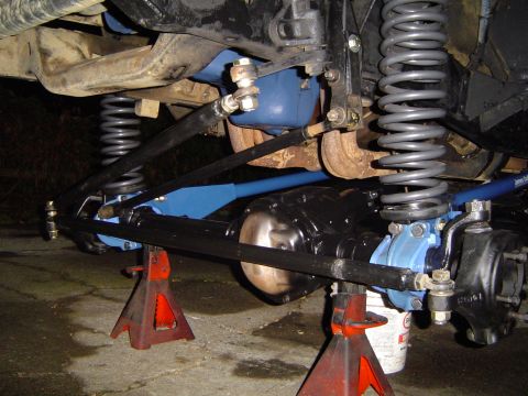1978 Ford Bronco - Undercarriage view of a vehicle's suspension system, showing springs, shocks, and differential.