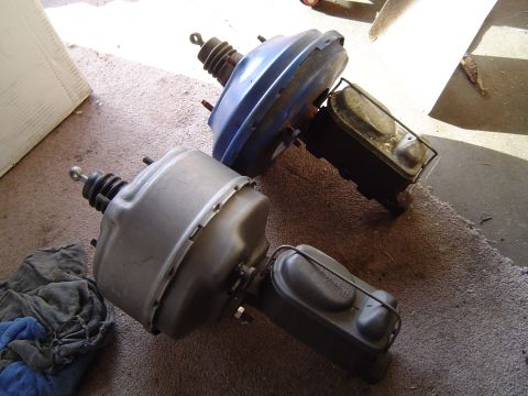 1978 Ford Bronco - Two automotive brake boosters and their associated master cylinders are shown, one in blue and the other in silver.