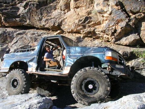 1994 Ford Bronco - A heavily modified Ford Bronco navigates a challenging rocky off-road course.