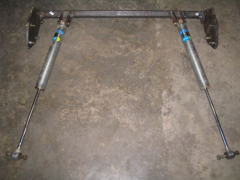 1989 Ford Bronco - Custom rear shock mount assembly with Bilstein shocks, likely for an off-road vehicle.