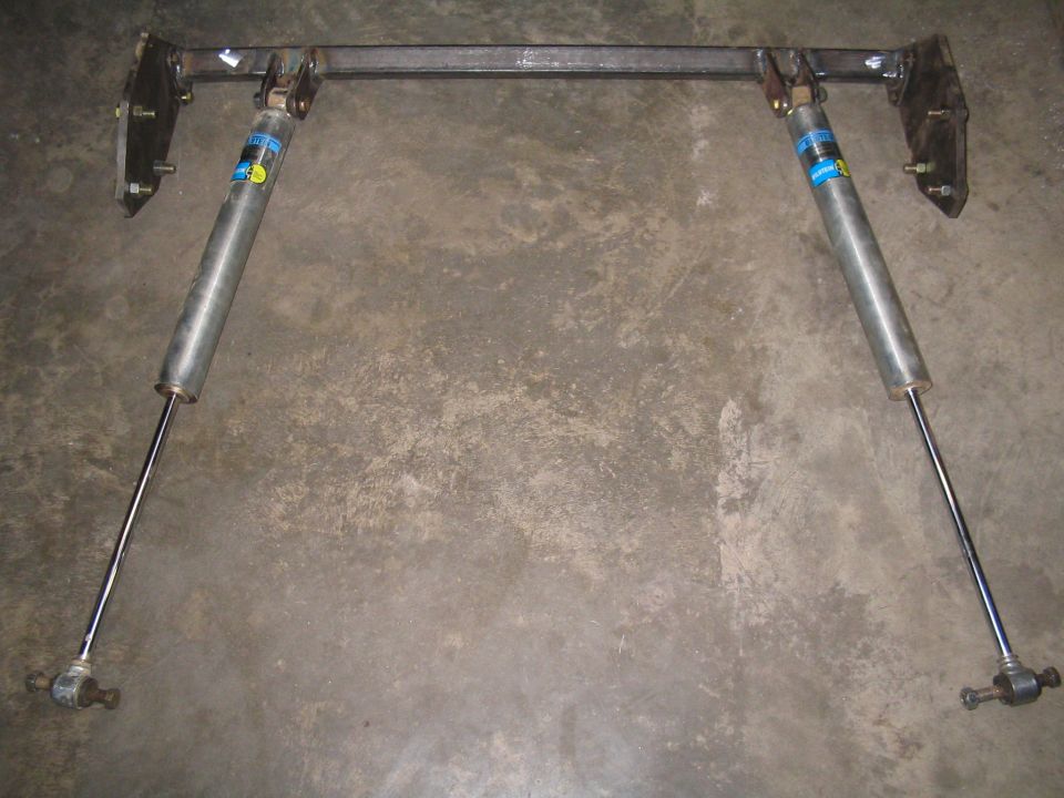 Rear shock mount assembly with two Bilstein shocks attached to a metal crossbar