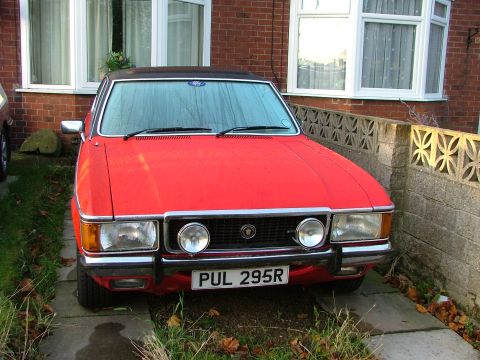 1976 Ford Granada - This red 1976 Ford Granada is parked in front of a brick house.