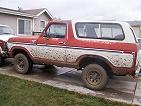 1984 Ford Bronco - This Ford Bronco is seen from the side, showing its two-tone paint and off-road condition.