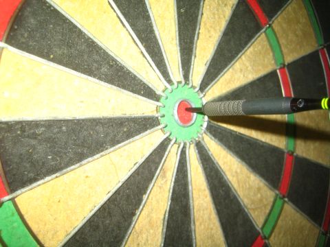 1968 Ford Mustang - A dart is embedded in the bullseye of a dartboard.