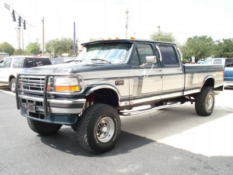 1993 Ford C-350 (Centurion Conversions) - This lifted pickup truck features a two-tone paint scheme and extensive chrome detailing.
