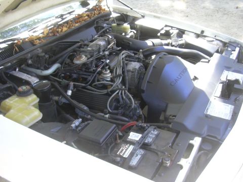 1997 Ford Crown Victoria - The engine bay of a 1997 Ford Crown Victoria, viewed from above, reveals the V8 engine and associated components.