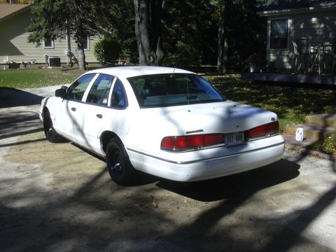 1997 Ford Crown Victoria - White 1997 Ford Crown Victoria parked in a driveway on a sunny day.