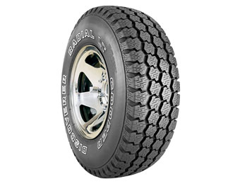 1993 Ford C-350 (Centurion Conversions) - Close-up of a Cooper Discoverer Radial LT tire mounted on a chrome wheel.