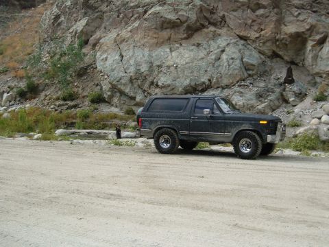 1981 Ford Bronco - This Ford Bronco is parked on a dirt road with a rocky hillside in the background.