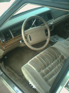 1985 Ford Crown Victoria LTD - Interior view of a car, showing the dashboard, steering wheel, and front seats. Text overlay indicates the source.