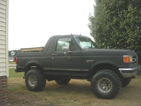 1989 Ford Bronco - cab closed in and painted flat black wooden thing is a dog box (kennel) for transporting dogs
