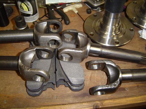 1978 Ford Bronco - Close-up view of driveshaft yokes and axle shafts, with some part numbers visible on the metal components.