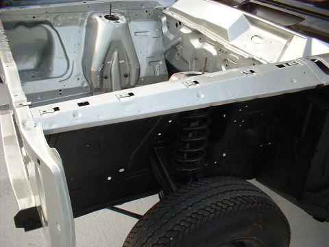 1967 Mercury Cyclone - The engine bay of a 1967 Mercury Cyclone undergoing restoration, revealing its chassis and suspension.