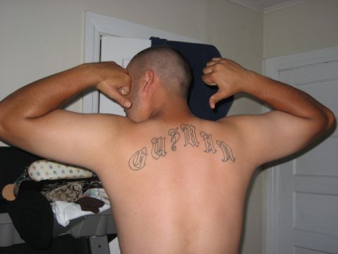 1993 Ford Bronco - A man displays a tattoo on his back.