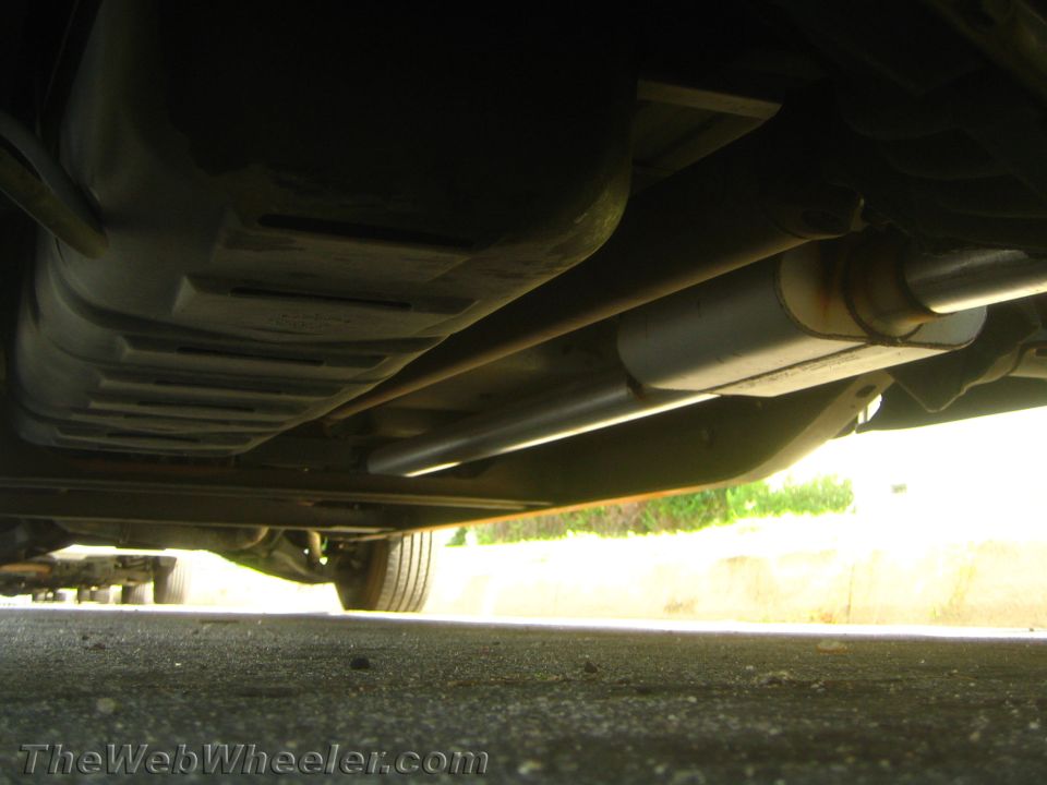 Underbody view of a lowered truck showing muffler, exhaust pipe and driveshaft