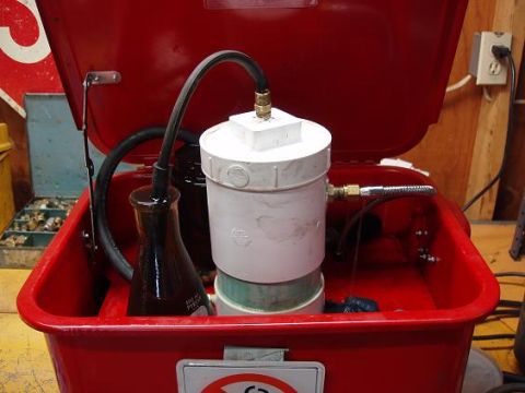 2001 Ford Excursion - A homemade device appears to be set up for transferring fluids, possibly for automotive maintenance.