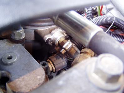 2001 Ford Excursion - Engine compartment detail with various mechanical components and a visible Supermotors logo.